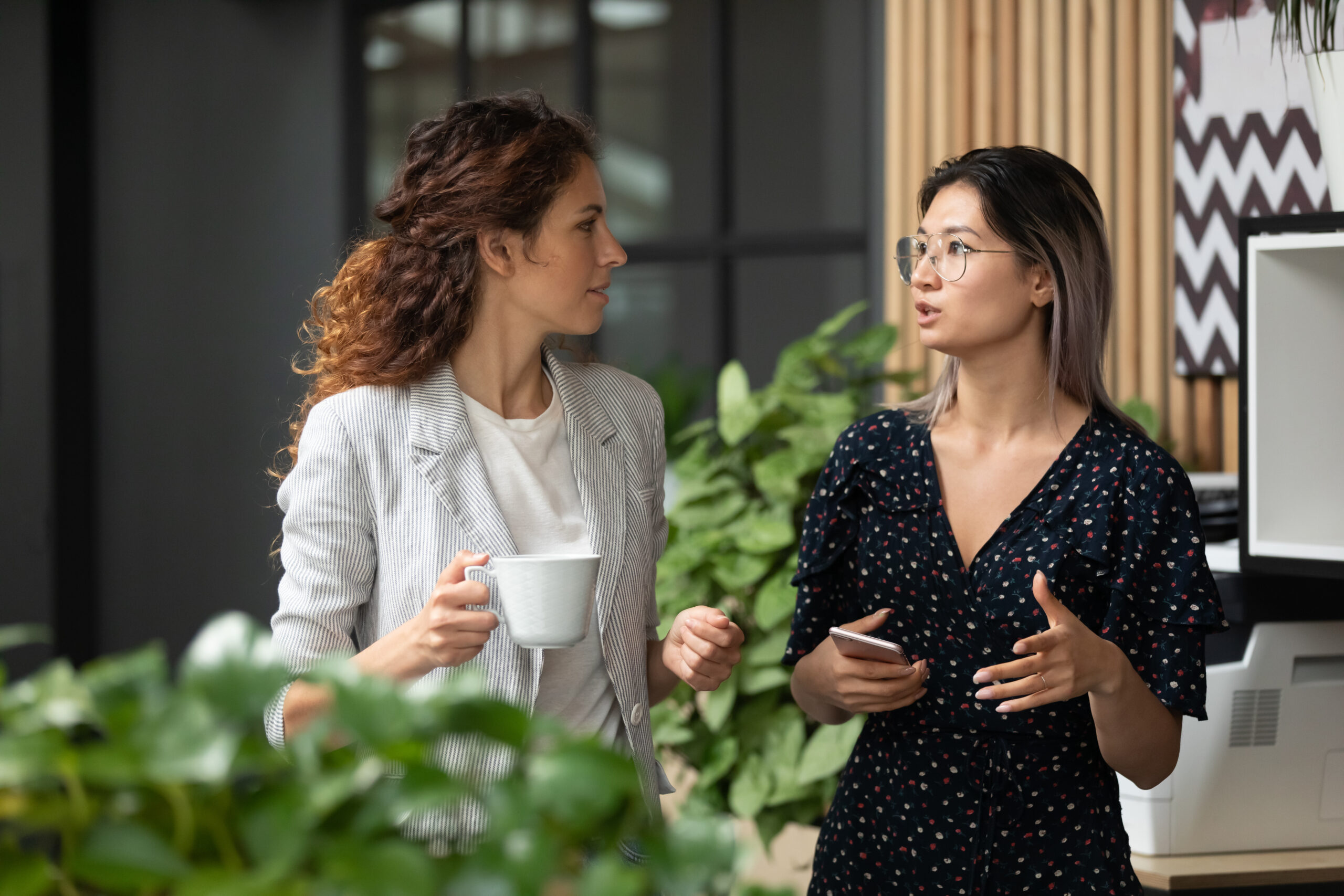 Diverse,Employees,Chatting,During,Coffee,Break,,Walking,In,Modern,Office,