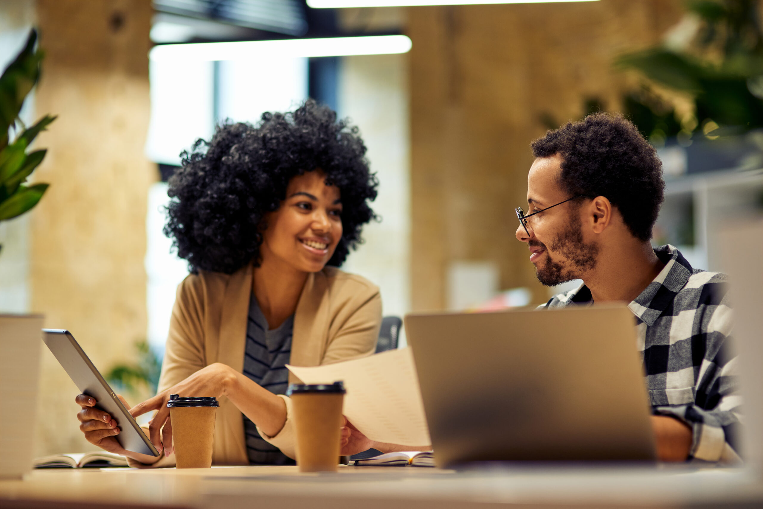 Sharing,Fresh,Ideas.,Two,Young,Happy,Multiracial,Business,People,Sitting